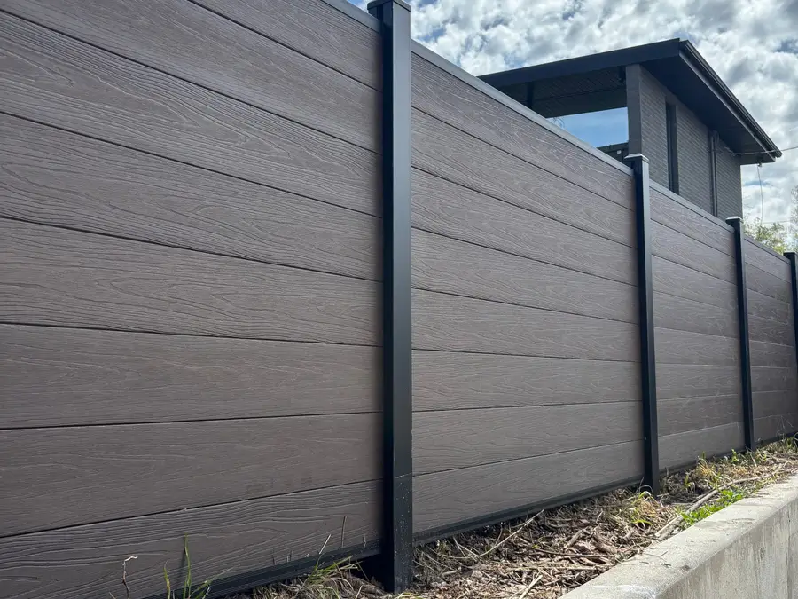 Composite fence panels and posts against a blue sky
