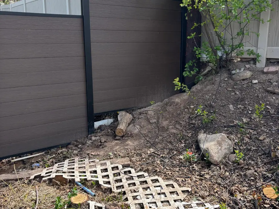 Composite privacy fence stepping down a sloped yard