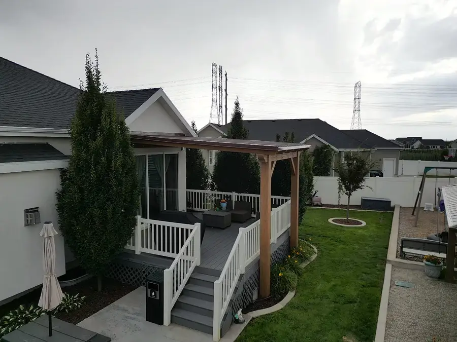Backyard deck with a pergola and seating, seen from above