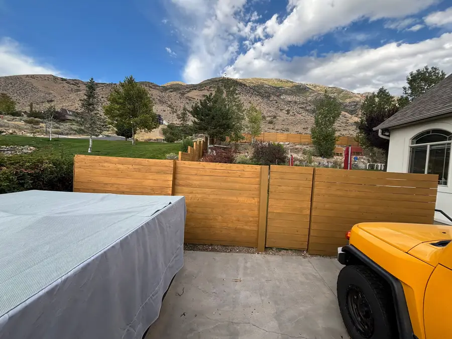 Horizontal cedar fence with mountains and sky behind