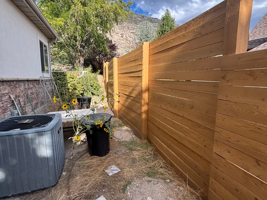Horizontal cedar fence along a side yard