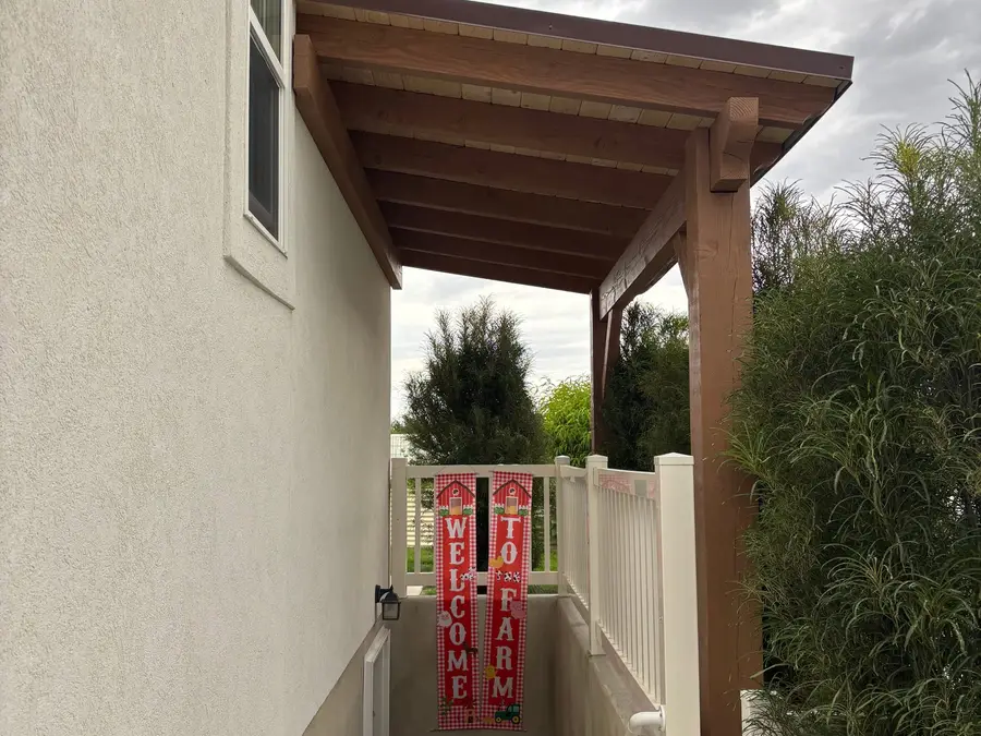 Small pergola roof over a side entry of a home